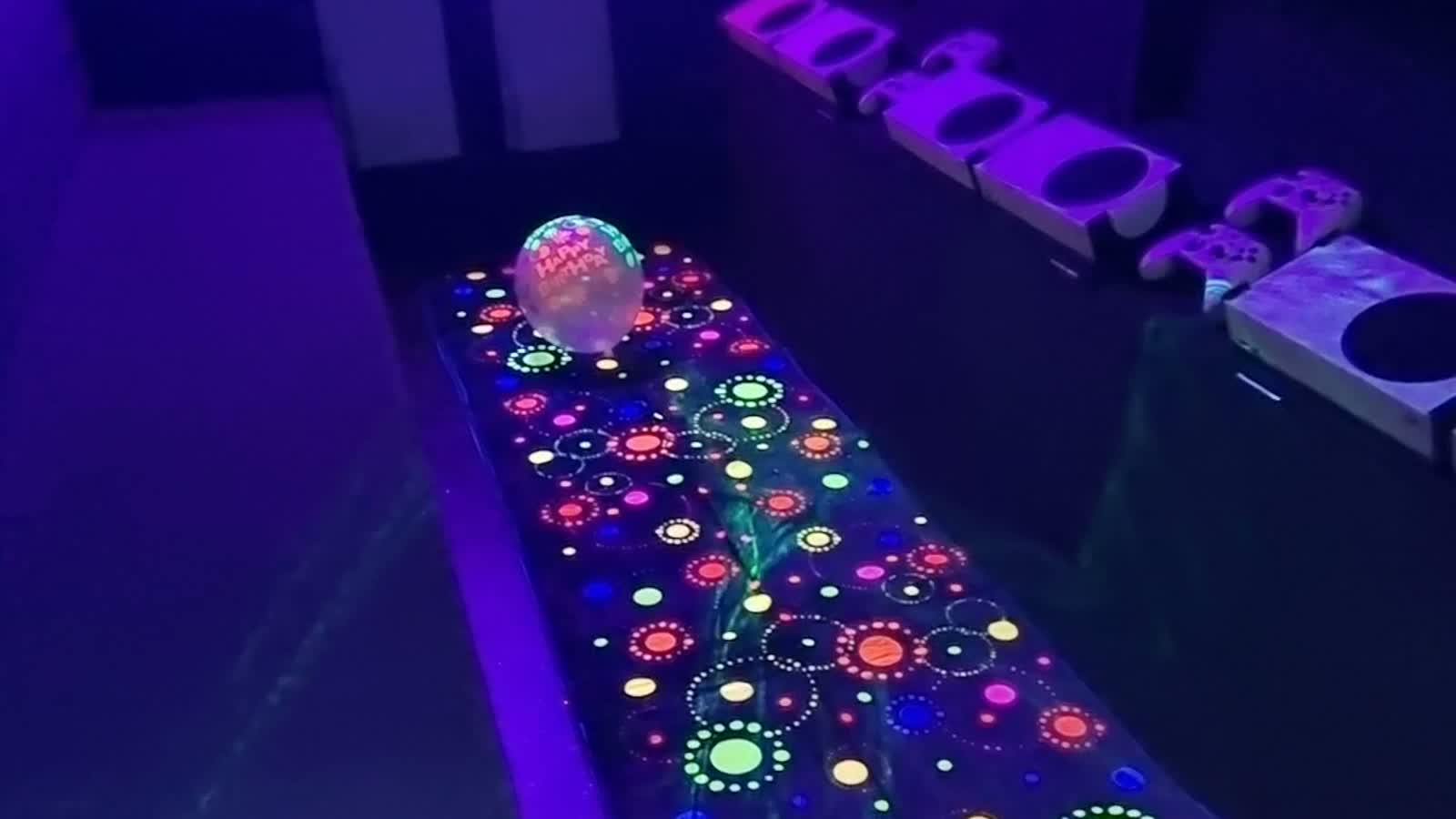 The fluorescent birthday carpet glowing beneath the van's UV lights